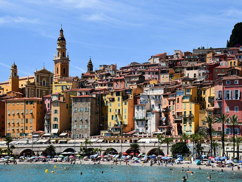 Menton's old town of tall ochre and pink houses and its bell tower above the beach