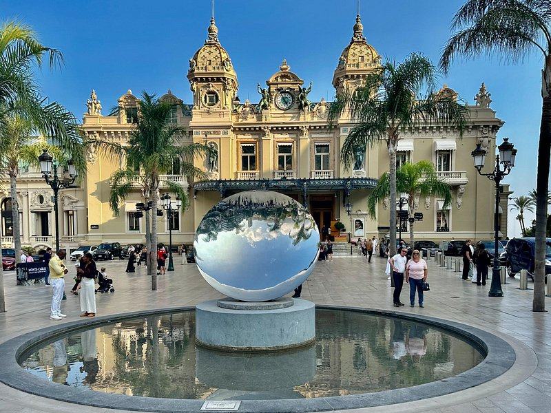 The casino at Monte-Carlo behind its square and a mirrored sculpture